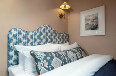 a bedroom with a bed with a blue and white pillow at Munro Guest House in Stirling