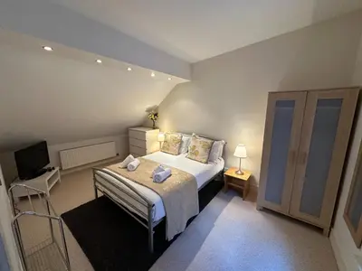 a bedroom with a bed and a television in it at Apartment Thistle Lane in Edinburgh