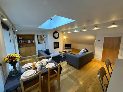 a living room with a dining table and a couch at Apartment Thistle Lane in Edinburgh