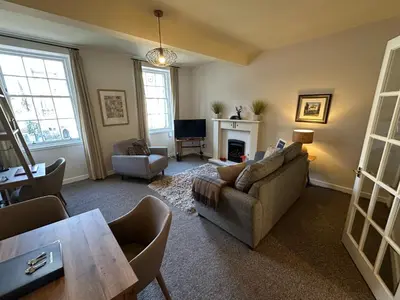 a living room with a couch and a fireplace at Castle Suite 3 Old Town in Edinburgh