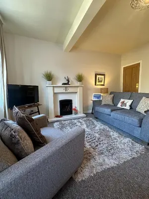 a living room with two couches and a fireplace at Castle Suite 3 Old Town in Edinburgh