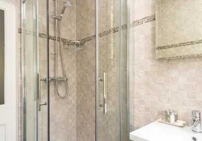 a bathroom with a shower and a sink at Castle Suite 3 Old Town in Edinburgh