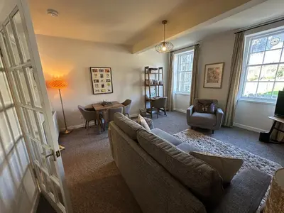 a living room with a couch and a table at Castle Suite 3 Old Town in Edinburgh