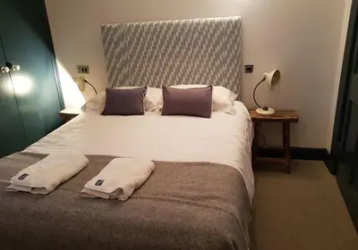 a bedroom with a large bed with towels on it at Thistle Suite city centre in Edinburgh