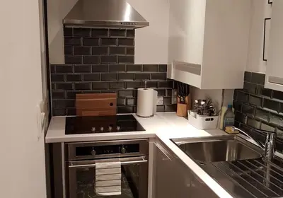 a small kitchen with a sink and a stove at Thistle Suite city centre in Edinburgh