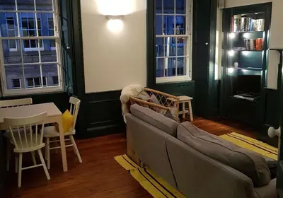 a living room with a couch and a table at Thistle Suite city centre in Edinburgh