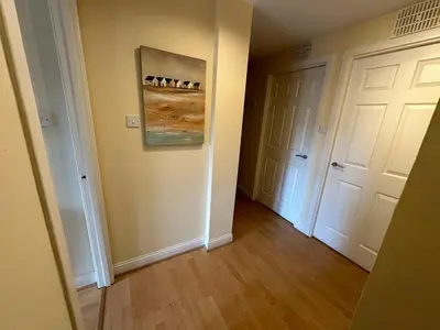 a hallway with two white doors and a painting on the wall at Castle Wynd Old Town in Edinburgh