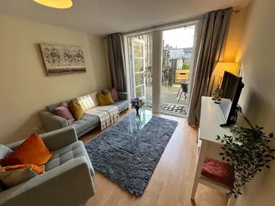a living room with a couch and a table at Castle Wynd Old Town in Edinburgh