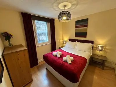 a bedroom with a bed with two teddy bears on it at Castle Wynd Old Town in Edinburgh
