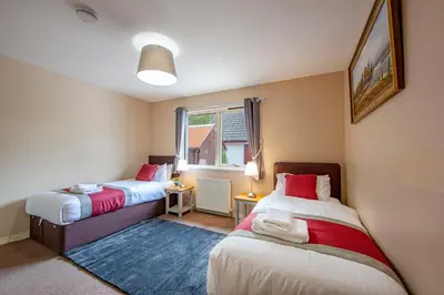 a bedroom with two beds and a window at Wildwood Cottage with Hot Tub in Glencoe