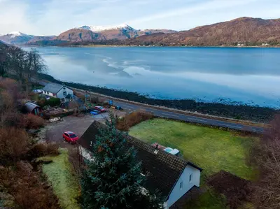 an aerial view of a lake with mountains in the background at Glenachulish Bay with Hot Tub in Glencoe