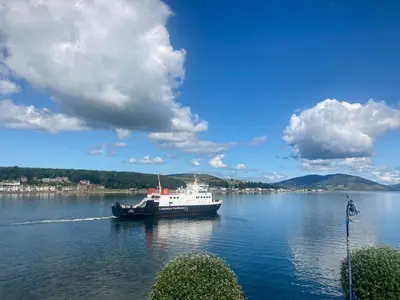 a boat floating on a large body of water at Cannon House Guest House in Rothesay
