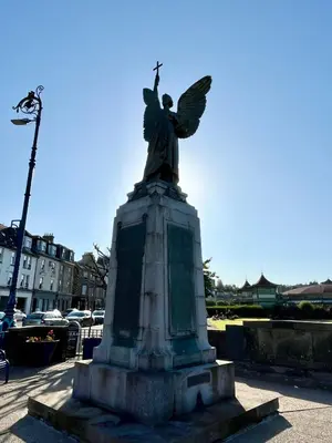 a statue of a woman with wings on top at Cannon House Guest House in Rothesay