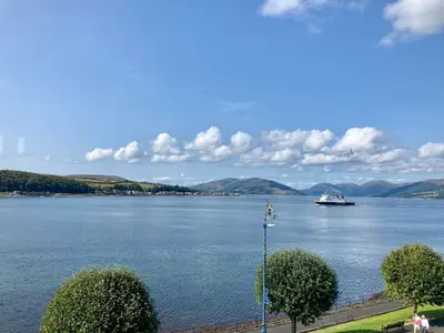 a boat on a large body of water at Cannon House Guest House in Rothesay