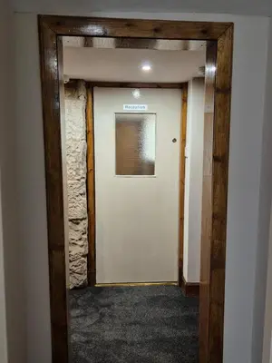 a doorway into a room with a white door at Douglas Hotel in Glasgow