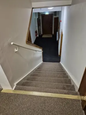 a staircase in an office building with a stair case at Douglas Hotel in Glasgow