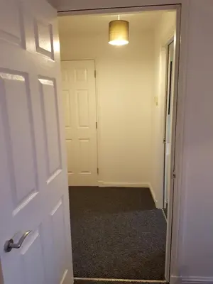 an empty room with a door and a hallway at Bathgate Contractor and Business Apartment in Bathgate