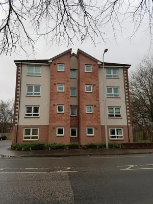 a large brick building on the side of a street at Bathgate Contractor and Business Apartment in Bathgate
