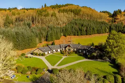 an aerial view of a large house in a field at Melfort Village in Oban