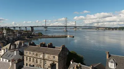 a bridge over a river with buildings and a city at Forth Reflections Self Catering in Queensferry