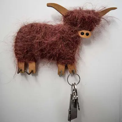 a stuffed animal is hanging on a wall with keys at Forth Reflections Self Catering in Queensferry