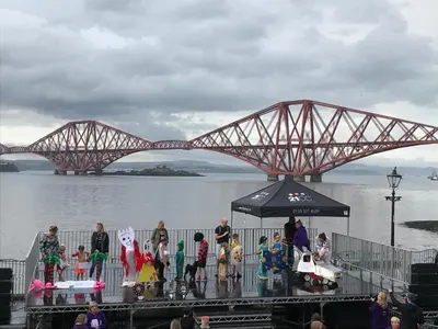 a group of people standing in front of a bridge at Forth Reflections Self Catering in Queensferry