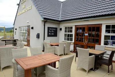 a restaurant with tables and chairs in front of a building at Highland Gate, Stirling by Marston's Inns in Stirling