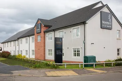 a white building with a sign in front of it at Highland Gate, Stirling by Marston's Inns in Stirling