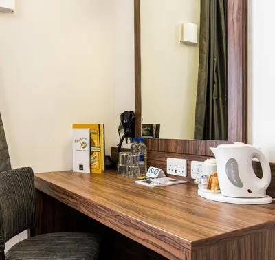 a desk in a hotel room with a coffee maker on it at Chain Runner, Livingston by Marston's Inns in Livingston
