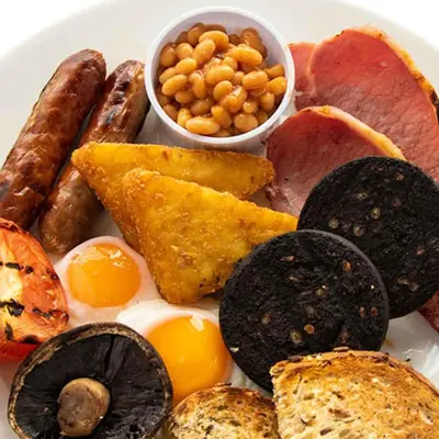 a plate of food with eggs sausage bread and beans at Chain Runner, Livingston by Marston's Inns in Livingston