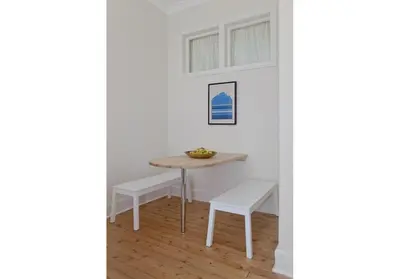 a dining room with a table and white chairs at The Edinburgh Address - Classic Marchmont Charm in Edinburgh