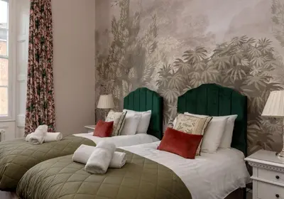 two beds with green headboards in a bedroom at Edinburgh Castle Suite - The Edinburgh Address in Edinburgh
