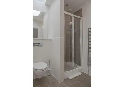 a bathroom with a toilet and a shower at The Skyline - The Edinburgh Address in Edinburgh