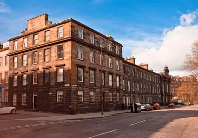 a large brick building on the side of a street at The Edinburgh Address - Castle View Apartment in Edinburgh