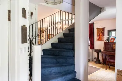 a blue staircase in a home with a piano at Strathendrick House Magnificent property with Garden in Drymen