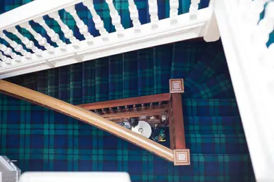 a set of stairs in a room with a blue and green wall at Brig O'Doon Guest House in Edinburgh
