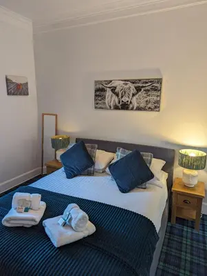 a bedroom with two beds with towels on them at Brig O'Doon Guest House in Edinburgh
