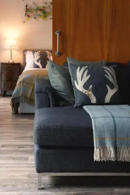 a bedroom with a bed and a couch and a bed at Riverside West End Apartment in Glasgow