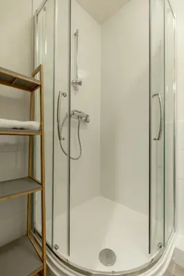 a shower with a glass door in a bathroom at The Wee Thistle in Edinburgh