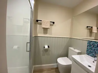 a bathroom with a shower and a toilet and a sink at Spacious cottage - walk to Crieff in Crieff