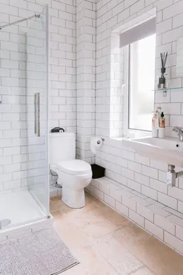 a bathroom with a toilet and a tub and a sink at Dunruadh Cottage in Gartocharn