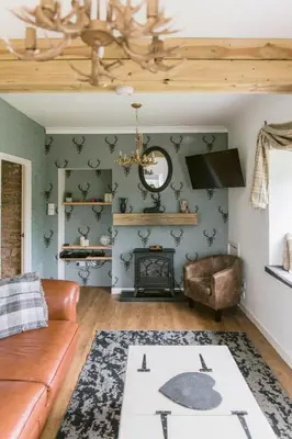 a living room with a couch and a fireplace at Dunruadh Cottage in Gartocharn