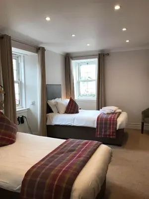 a hotel room with two beds and a window at The Inverkip Restaurant, Bar & Hotel in Inverkip