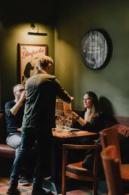 a group of people sitting at a table in a restaurant at The Inverkip Restaurant, Bar & Hotel in Inverkip