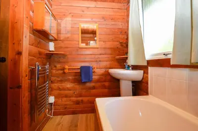 a bathroom with a toilet and a sink and a tub at 18 Lamont Lodges in Dunoon