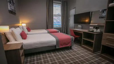 a hotel room with a bed and a desk at Best Western Glasgow Hotel in Glasgow