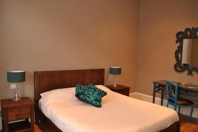 a bedroom with a bed with a green pillow on it at Dreamhouse Apartments Glasgow West End in Glasgow