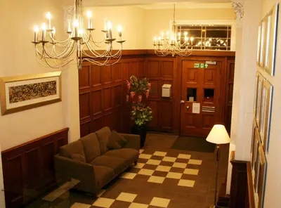 a living room with a couch and a chandelier at Dreamhouse Apartments Glasgow West End in Glasgow