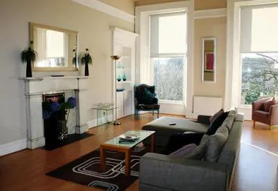 a living room with a couch and a fireplace at Dreamhouse Apartments Glasgow West End in Glasgow