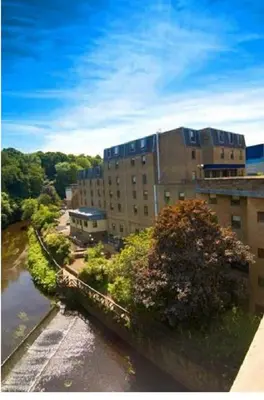 a building next to a river with a building at Britannia Edinburgh Hotel in Edinburgh